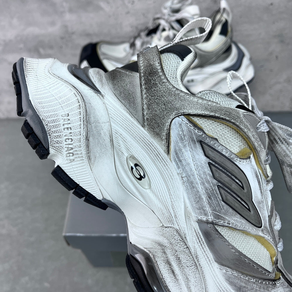 Unisex Balenciaga sneakers, silver upper with gold logo panel, lace-up, rugged black sole