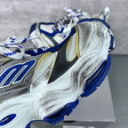 Balenciaga unisex sneaker, close-up side; metallic silver, blue logo patch, lace-up