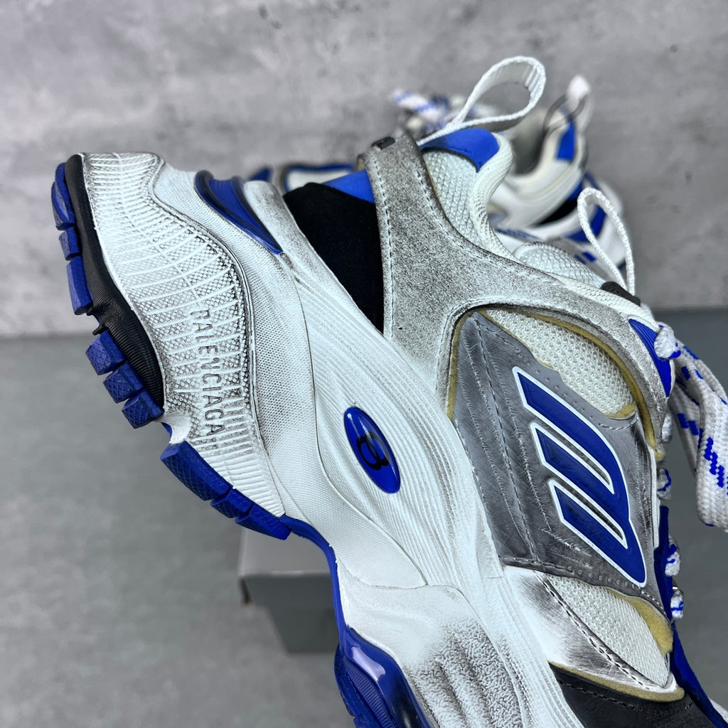 Balenciaga unisex sneaker, angled side view; silver upper with blue sole and laces