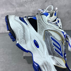 Balenciaga unisex sneaker, angled side view; silver upper with blue sole and laces