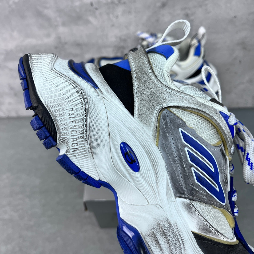Balenciaga unisex sneaker, angled side view; silver upper with blue sole and laces
