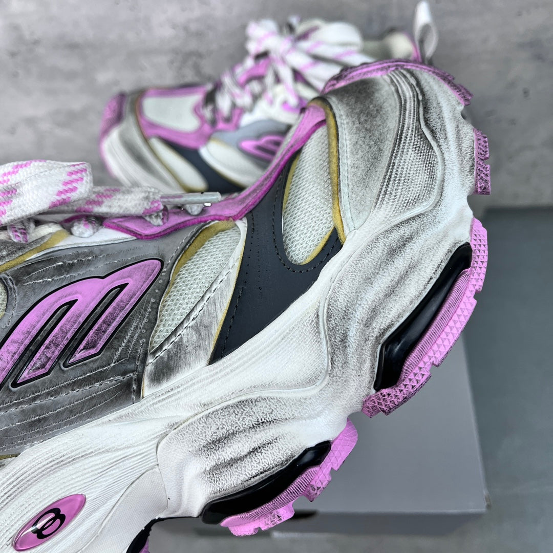 Silver sneaker with purple detailing, textured panels and lace-up closure on box