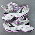 Two-tone silver and white sneaker with purple accents, chunky sole, lace-up and straps