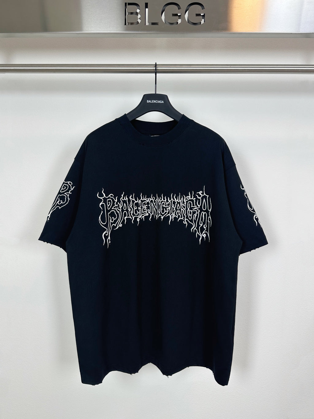 Black T-shirt with white gothic logo graphic across chest