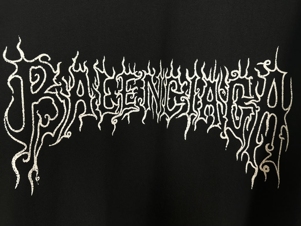 Black T-shirt close-up of white gothic dripping logo lettering