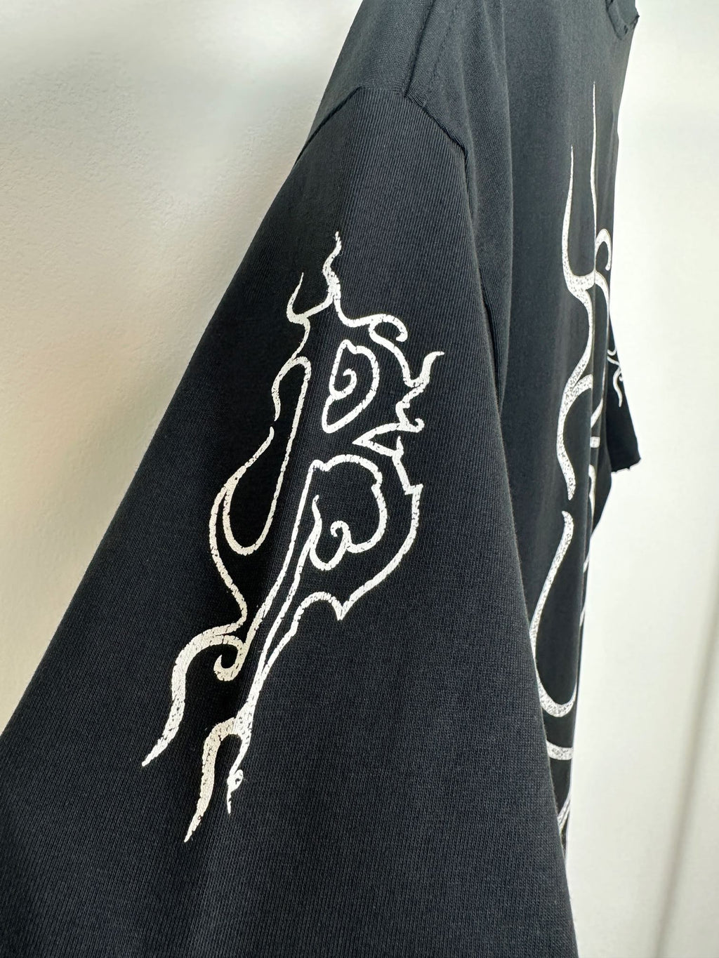 Black T-shirt back and sleeve with partial white logo print