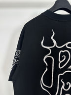 Black T-shirt back with partial white flame monogram graphic
