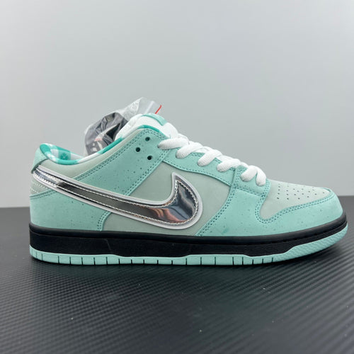 Mint teal low-top sneakers with white laces, silver swoosh and black midsole