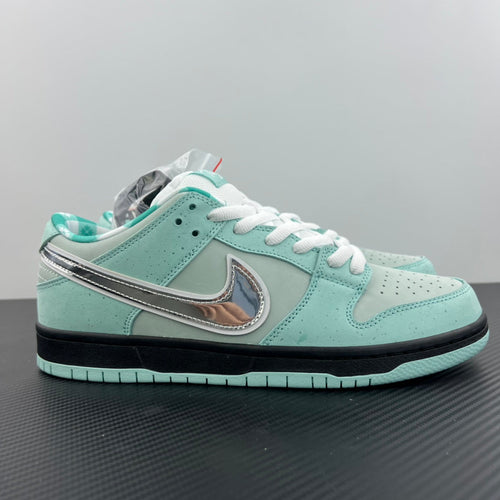 Mint teal low-top sneakers with white laces and swoosh on side, black sole