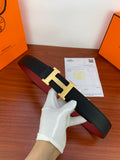 Hermes belt in black textured leather with gold H buckle, shown folded