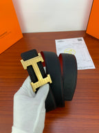 Hermes belt with black leather strap and large gold H buckle