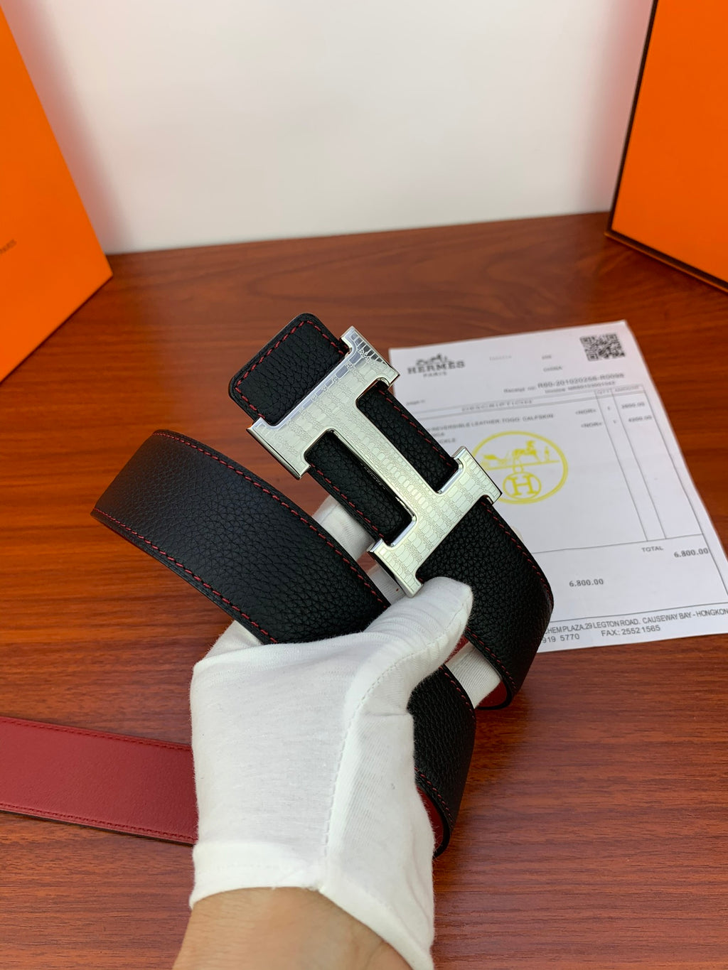 Hermes belt close-up: black leather strap with silver-toned H buckle