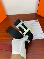 Hermes belt close-up: black leather strap with silver-toned H buckle