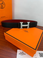 Hermes belt with black textured leather strap and silver-toned H buckle