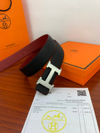 Hermes belt in black leather with silver-toned H buckle, side angle