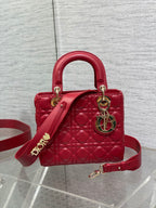 Red quilted Dior handbag with top handles, crossbody strap, gold hardware and logo charm