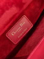 Red leather Dior label reading Christian Dior PARIS MADE IN ITALY