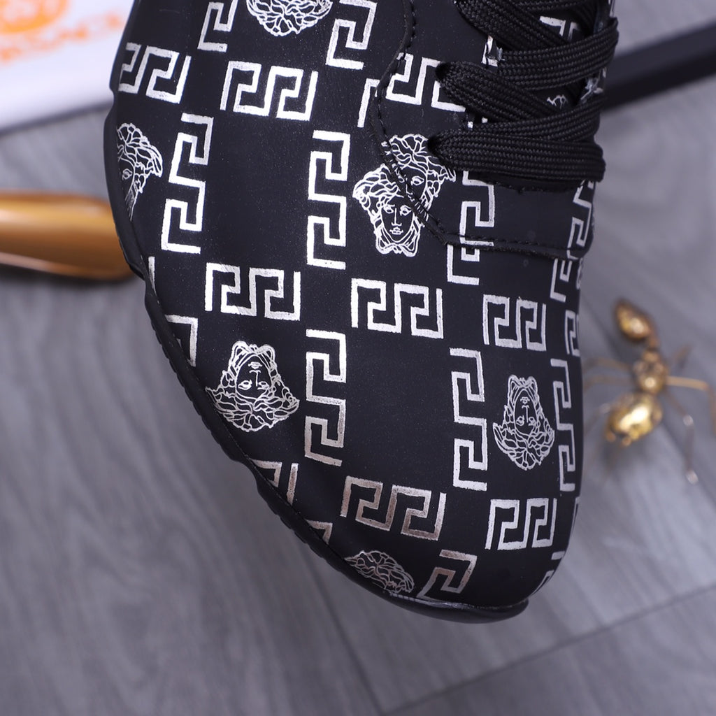 Versace luxury shoes close-up of dark upper with white geometric pattern and lion graphic