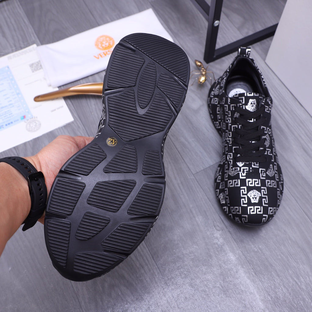Versace luxury shoes outsole view with dark ribbed rubber tread and white pattern upper