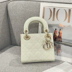 Cream quilted Dior handbag with glossy top handles and gold hardware