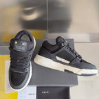 Amiri sneakers with dark knit upper, black lace-up front, and white midsole