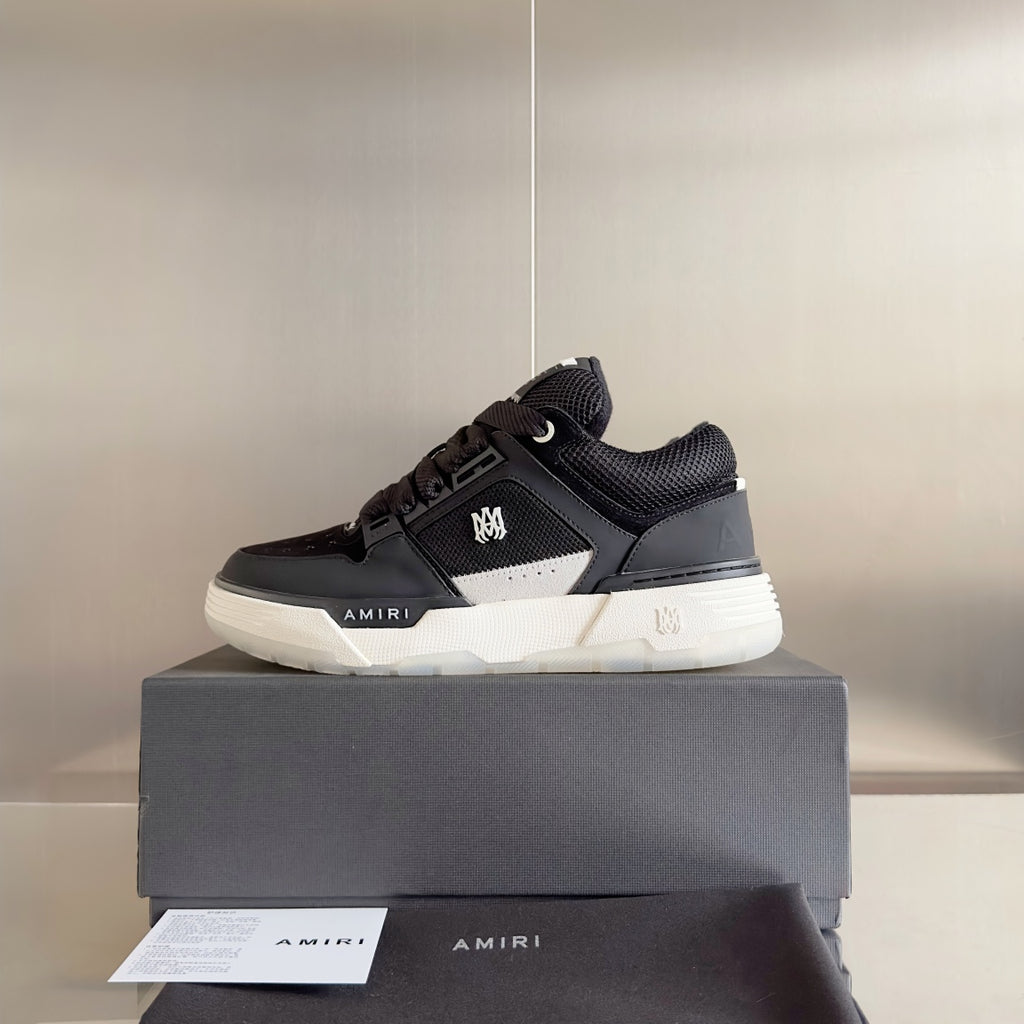 Amiri black lace-up sneaker on a dark shoe box, white midsole and side logo