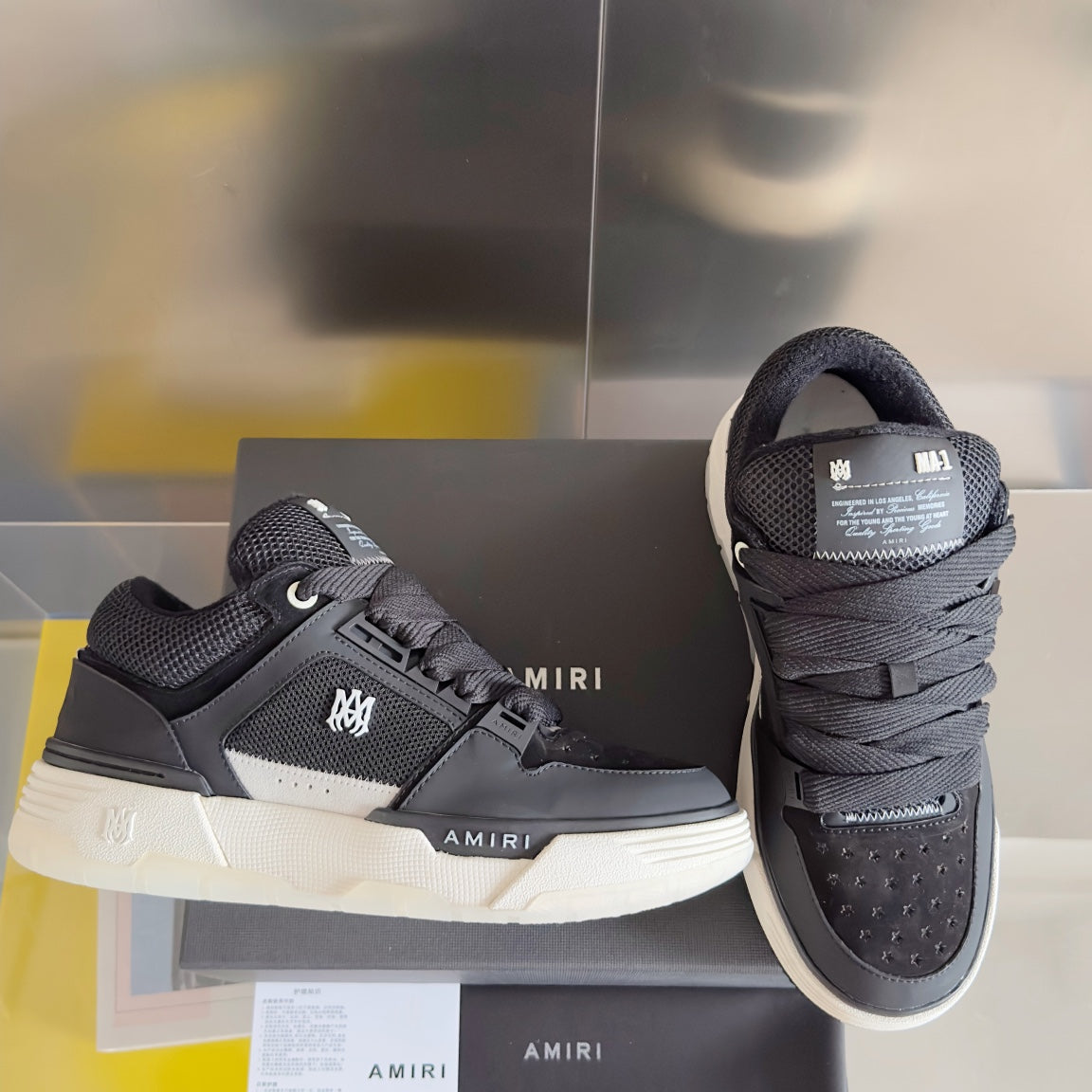 Amiri high-top sneakers, dark upper with white stripe detail and chunky white sole