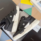 Amiri sneakers with black upper, white midsole, and logo patches, pair in box