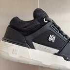 Amiri close-up sneaker: dark mesh upper, white midsole, and side logo patch