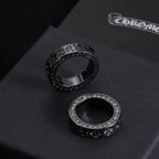 Two rings: one dark-tone with engraved band, one silver-tone with crystal outer edge