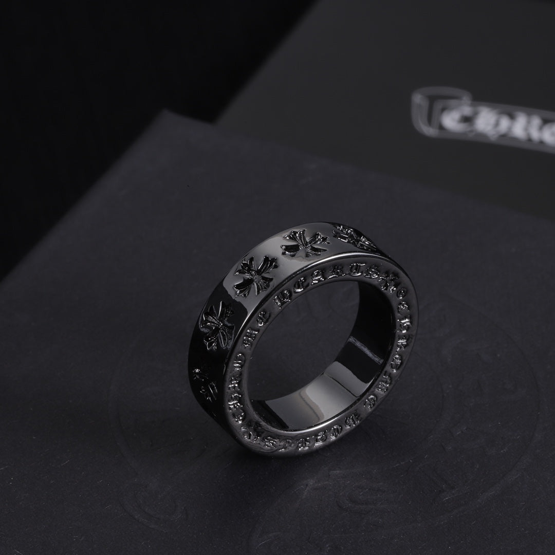 Single dark-tone ring with engraved pattern along the band and crystal trim