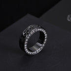 Dark-tone statement ring with crystal halo border and engraved side details