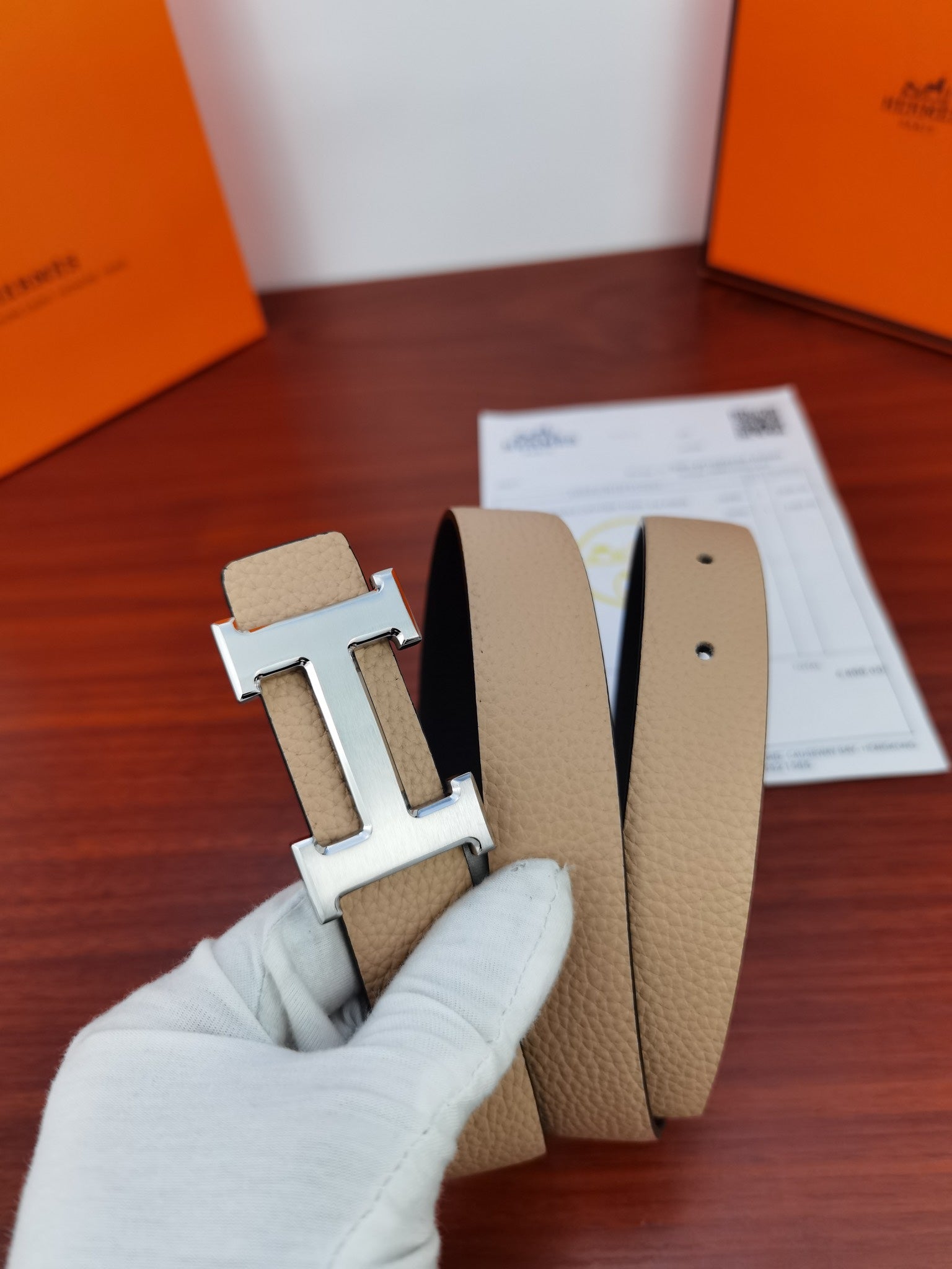 Hermes reversible belt buckle on light beige leather strap with matching keeper holes