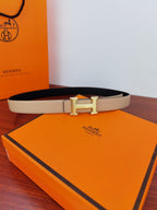 Hermes reversible leather belt with light beige strap and gold-tone H buckle centerpiece