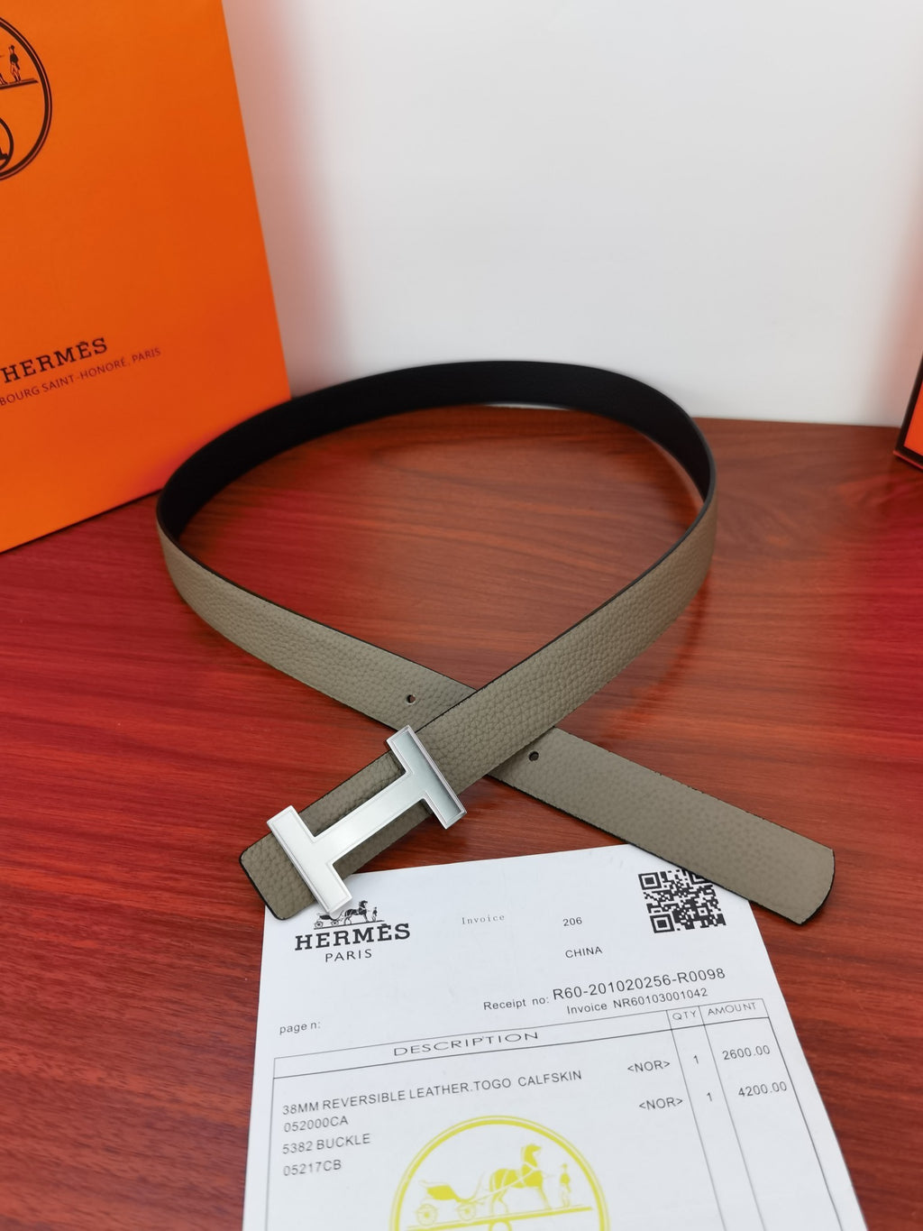 Reversible leather belt with light gray strap and silver-tone buckle