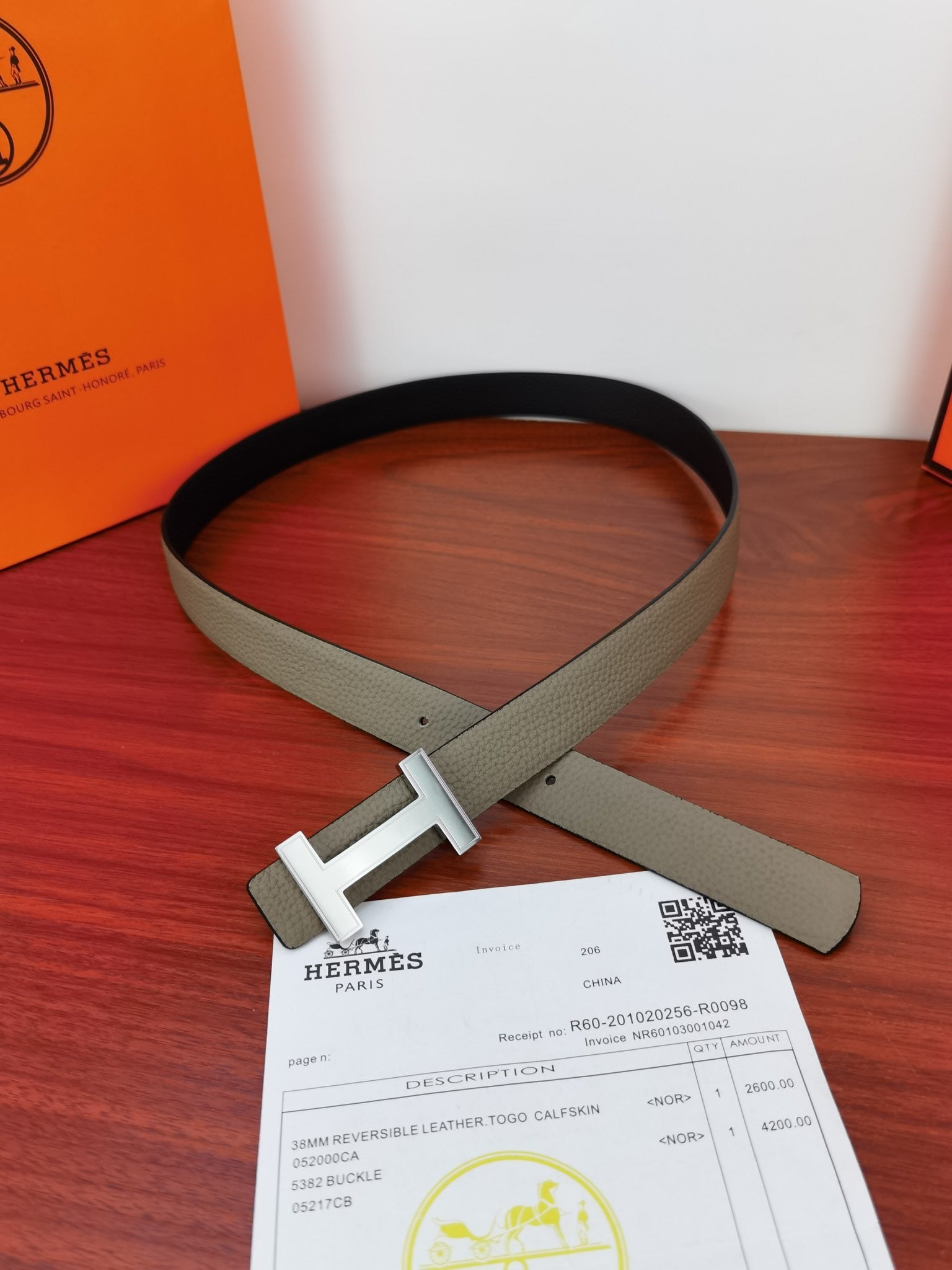Reversible leather belt with light gray strap and silver-tone buckle