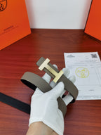 Reversible leather belt with light gray strap and silver-tone buckle