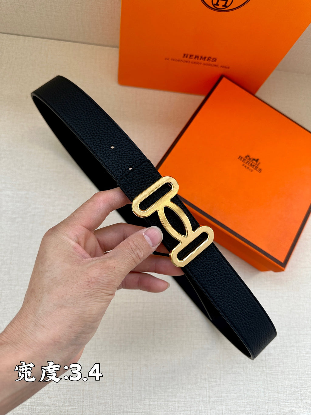 Dark leather belt with silver-toned double-loop buckle close-up