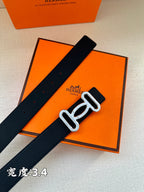 Dark leather belt with silver-toned buckle; textured strap with punched holes