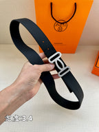 Dark leather belt with silver-toned buckle, side angle view