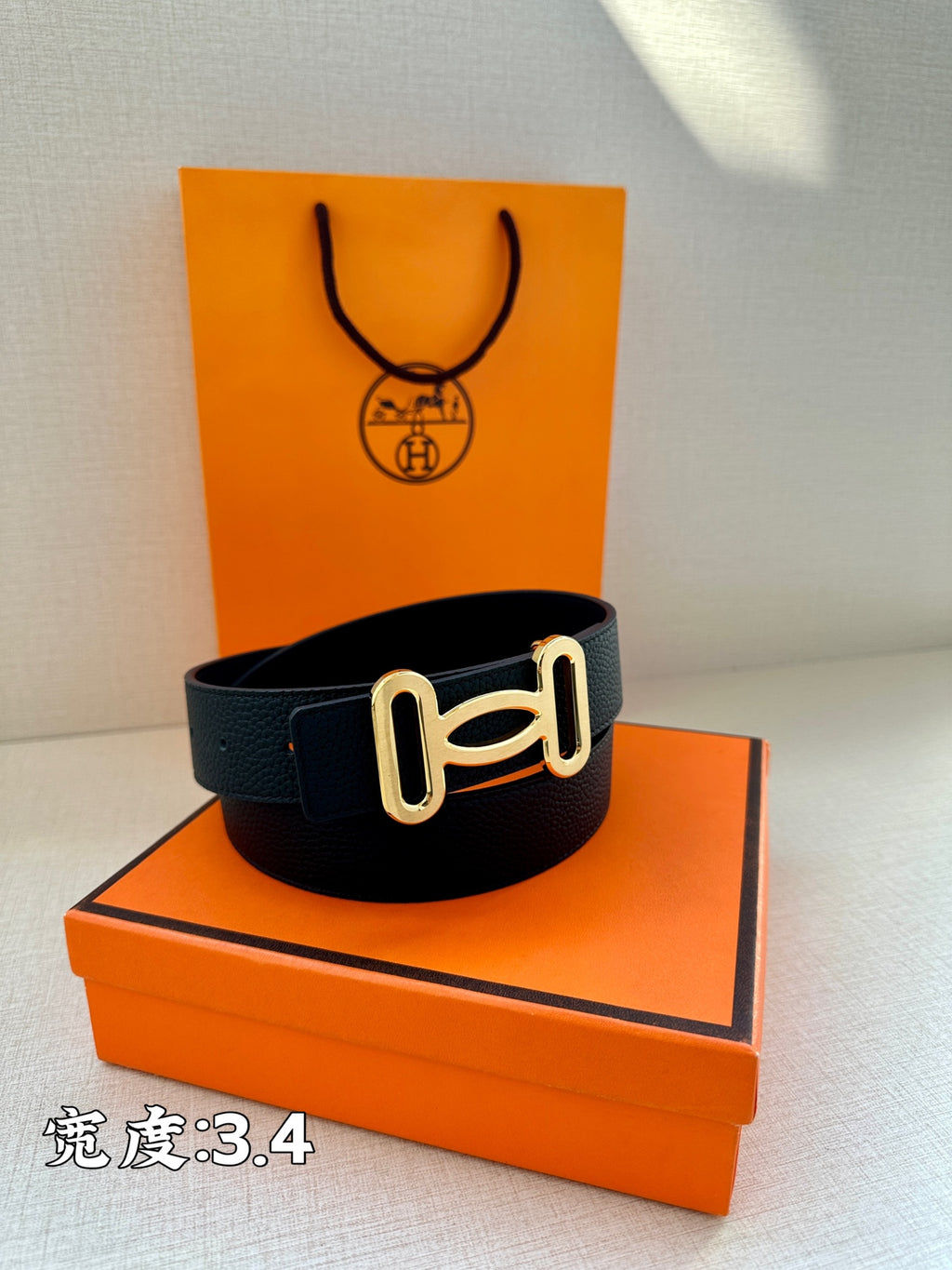 Dark leather belt with silver-toned buckle and adjustable strap holes