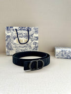 Dior belt on tabletop, dark logo strap with silver D buckle
