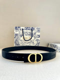 Navy fabric belt with gold-tone D buckle and textured strap detailing