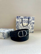 Navy fabric belt with silver-tone D buckle and embossed strap texture
