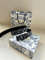 Dior logo belt with dark patterned band and large silver-toned buckle
