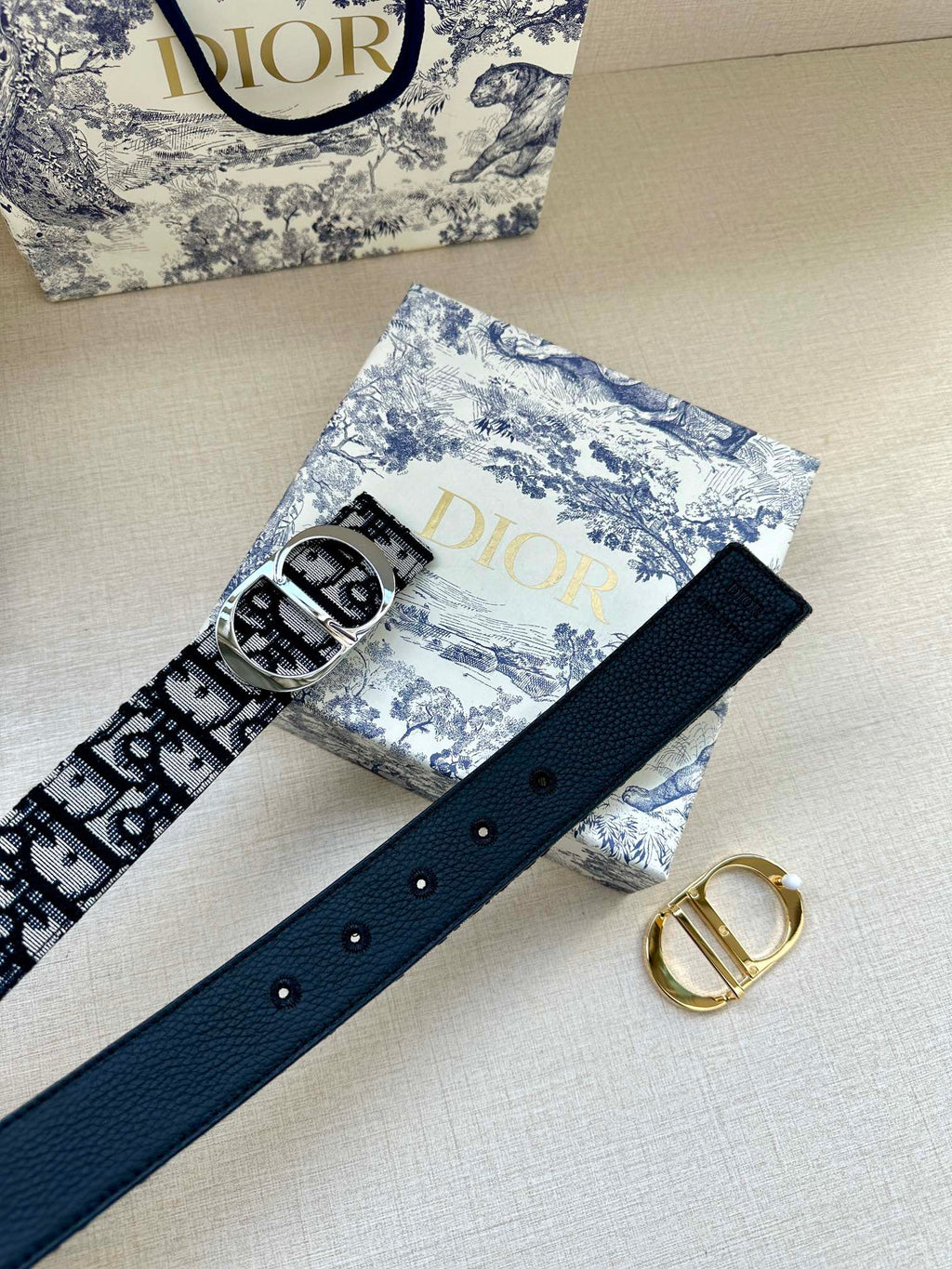 Navy leather belt with silver buckle and evenly spaced eyelets