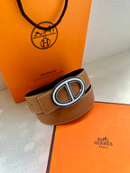 Tan leather belt with O-shaped silver buckle and stitched keeper loop