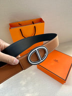 Tan leather belt with O-shaped silver buckle and visible black underside