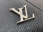 Louis Vuitton LV metal logo detail on textured black leather bag