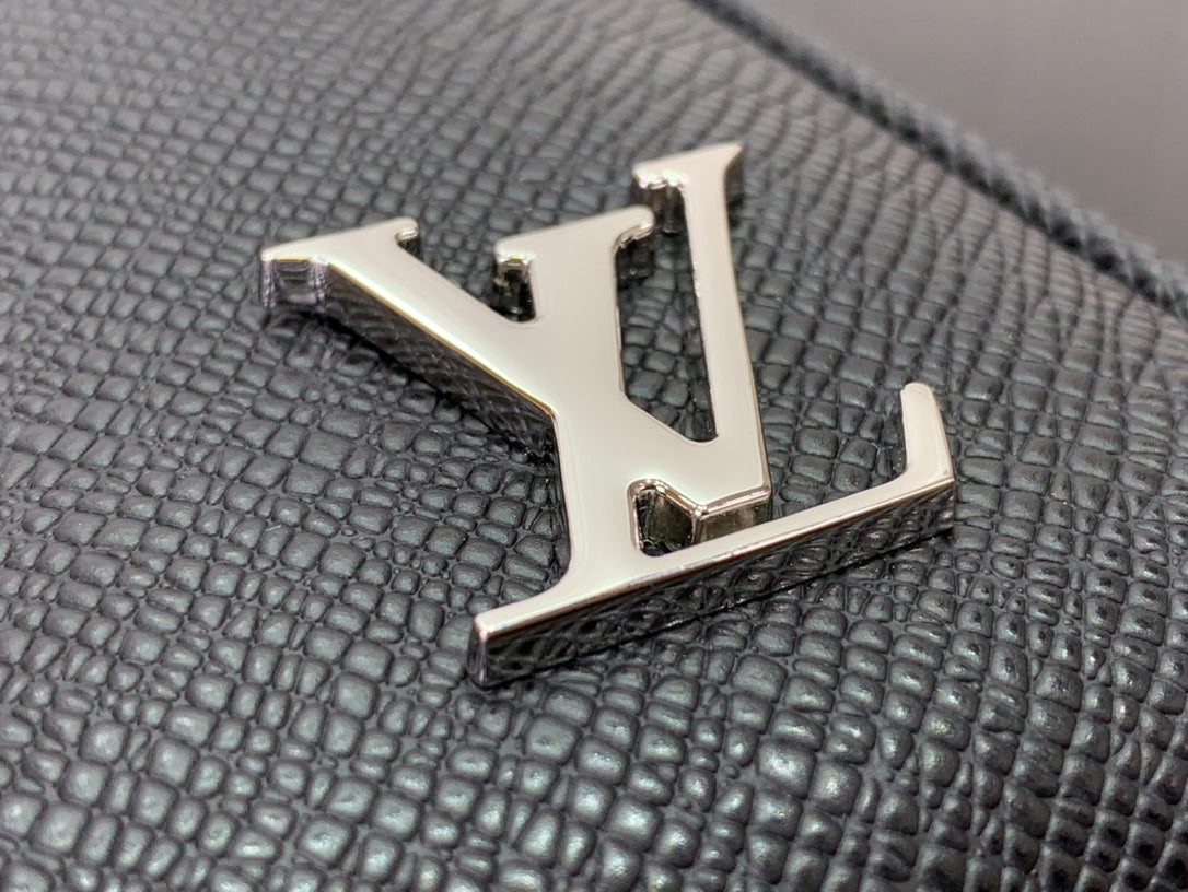 Louis Vuitton LV metal logo detail on textured black leather bag